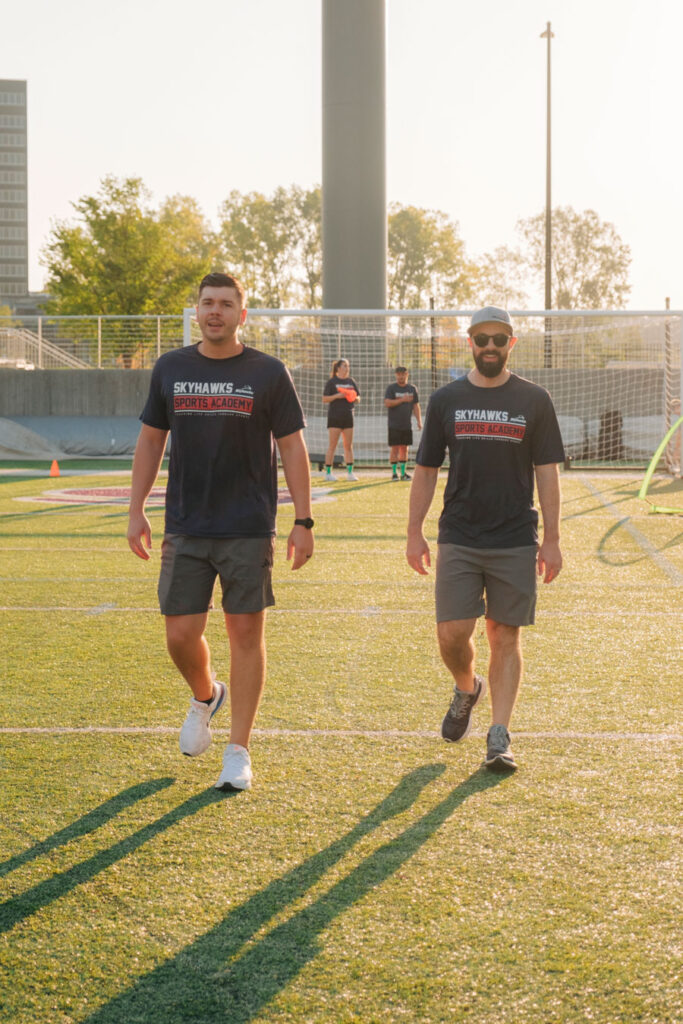 Two coaches walking.