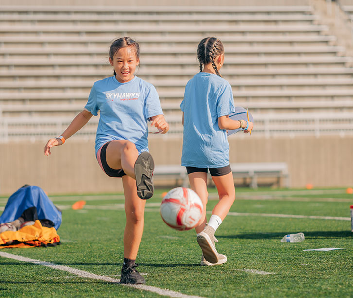 two people playing soccer.